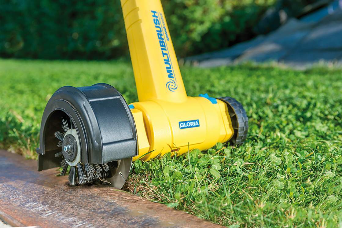 Der 2-in-1 Kantenschneider Cut&Brush befreit Steinwege und Bordsteine von überstehendem Gras, gleichzeitig reinigt die Nylon-Bürste die Steinfläche.